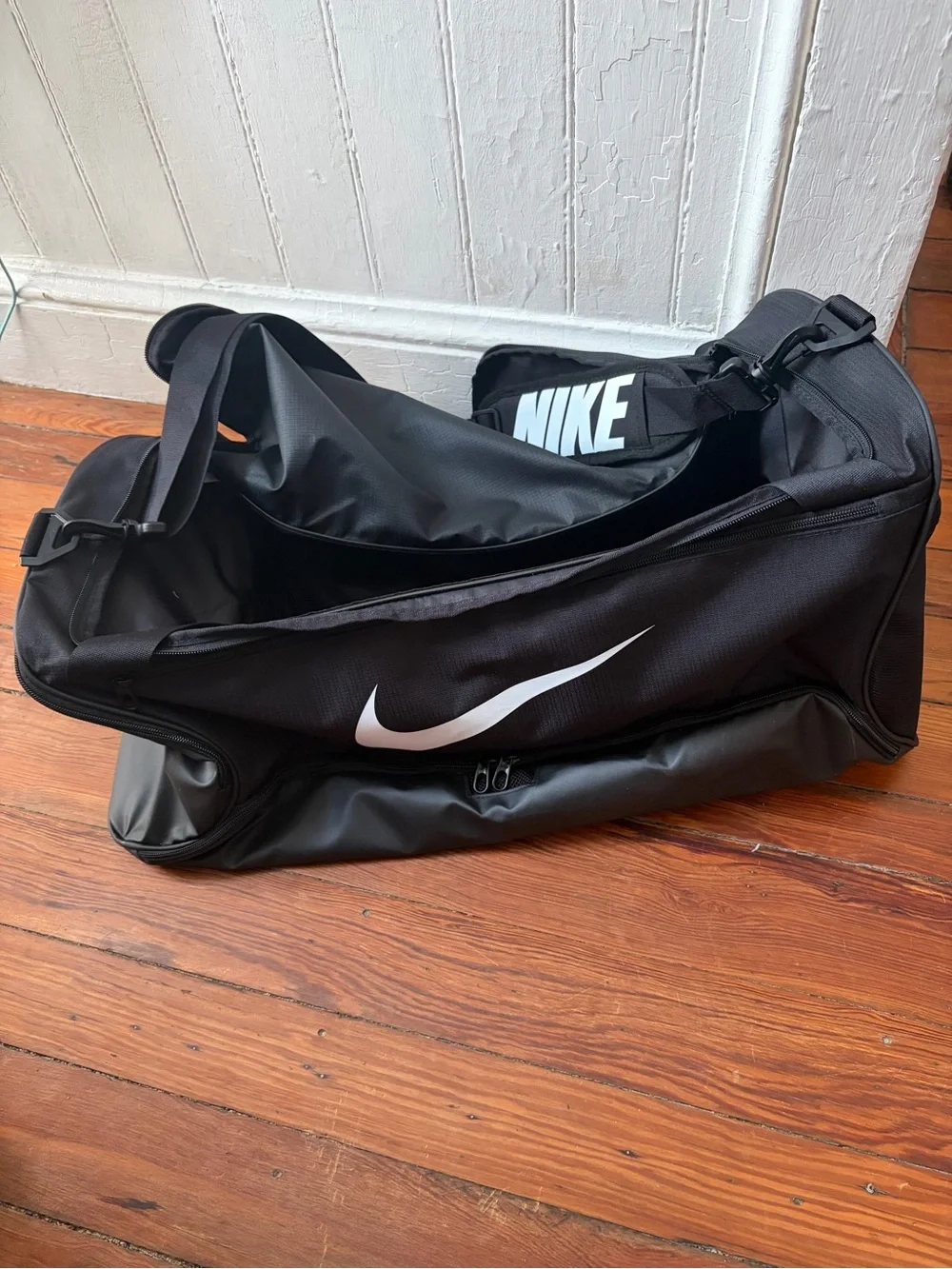 Nike Black Duffel Bag with White Swoosh and Strap Logo